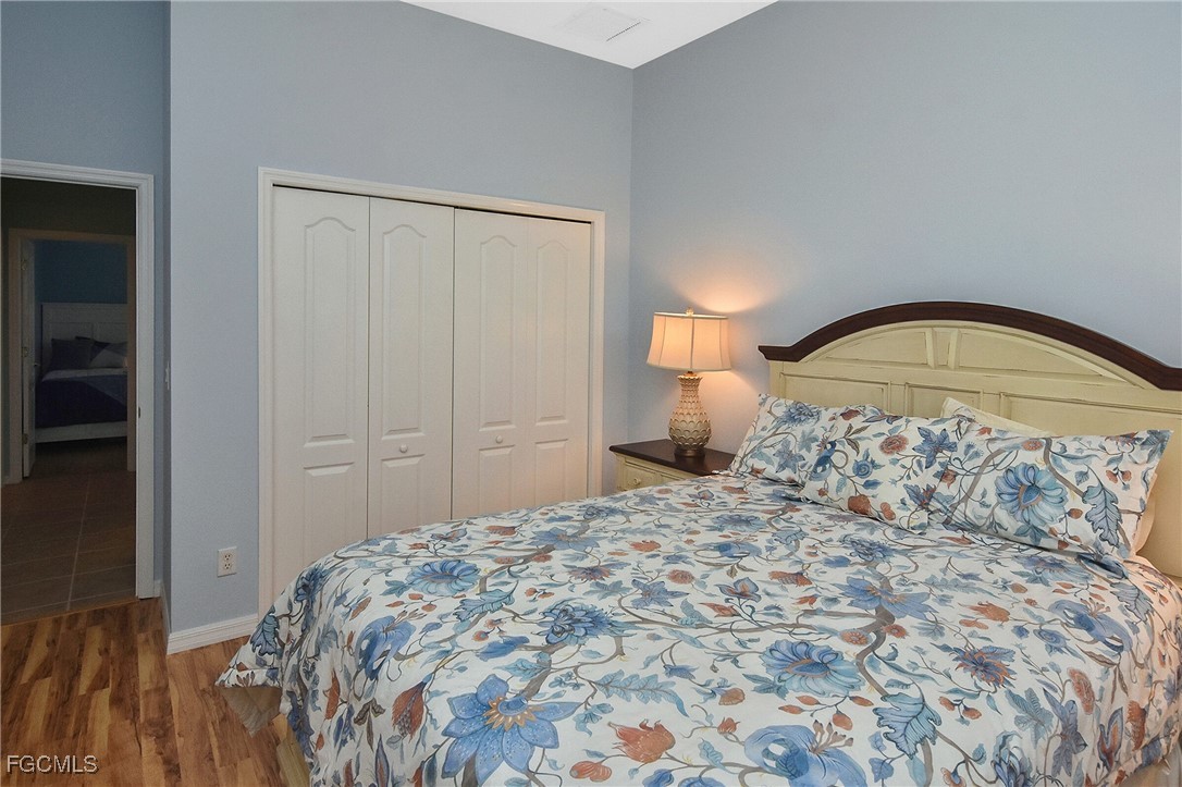 11131 Wine Palm Road Fort Myers, FL 33966 - Photo 38 of 48 a bedroom with a bed and a mirror