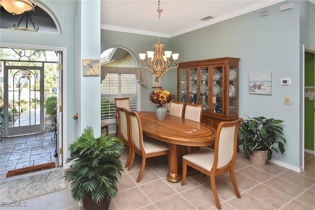 11131 Wine Palm Road Fort Myers, FL 33966 - Photo 9 of 48 a view of a dining room with furniture and chandelier