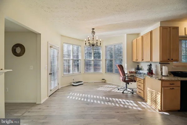 a view of a livingroom with workspace and a window