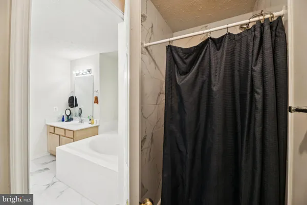 a view of walk in closet with clothes