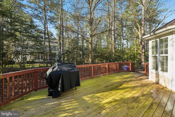 a view of roof deck with wooden fence and floor