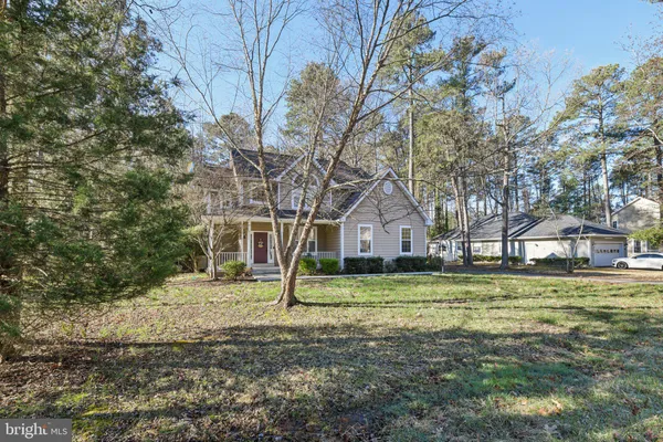 a house that has a tree in front of it