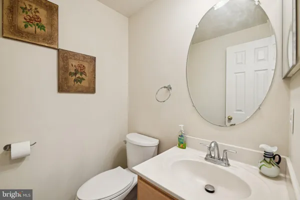 a bathroom with a sink mirror and toilet