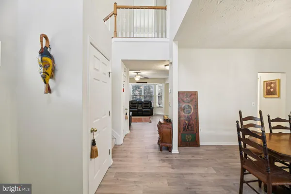a view of a hallway with furniture and wooden floor