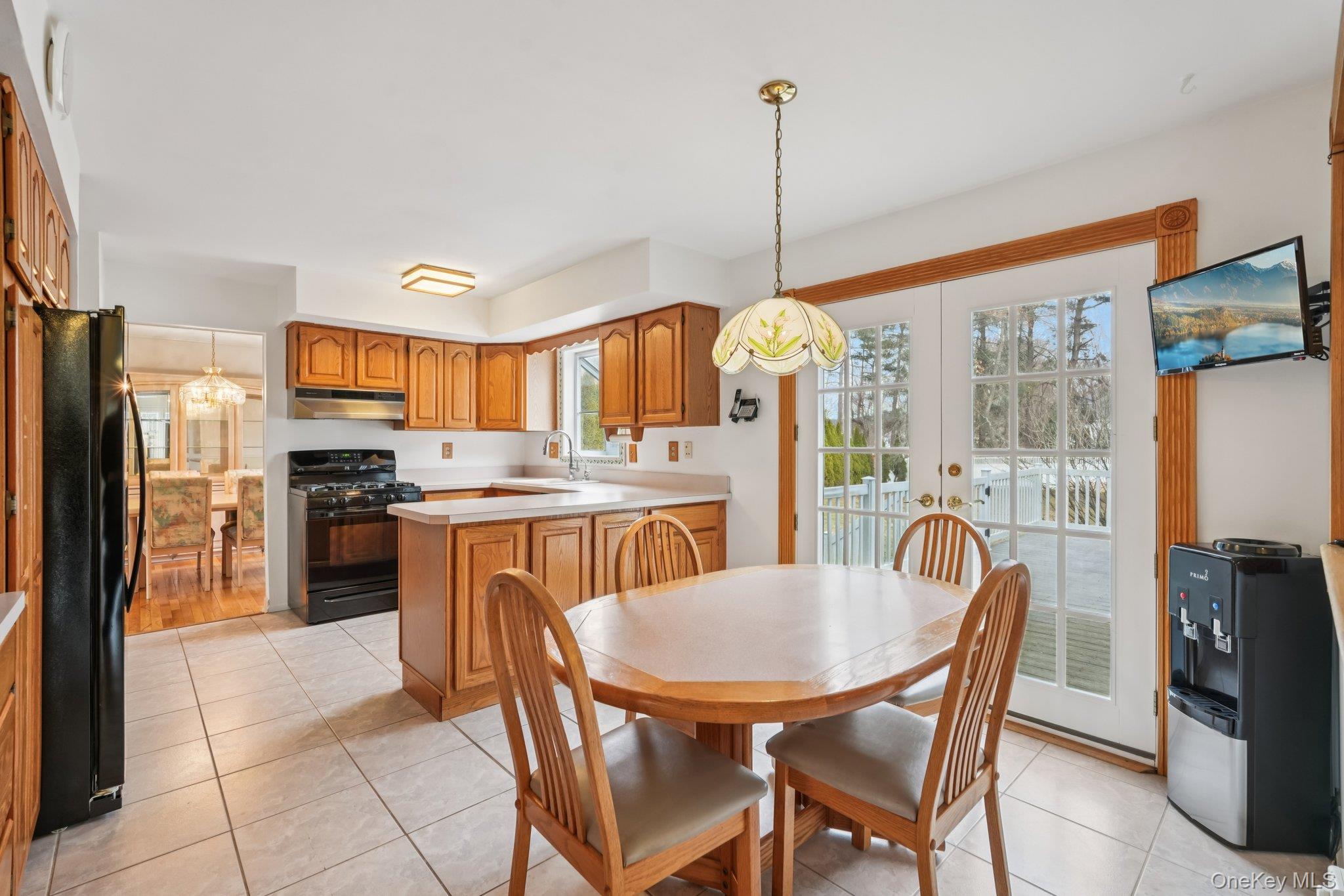 23 Oriole Road New City, NY 10956 - Photo 11 of 43 a kitchen with stainless steel appliances granite countertop a stove a refrigerator a kitchen island a table and chairs