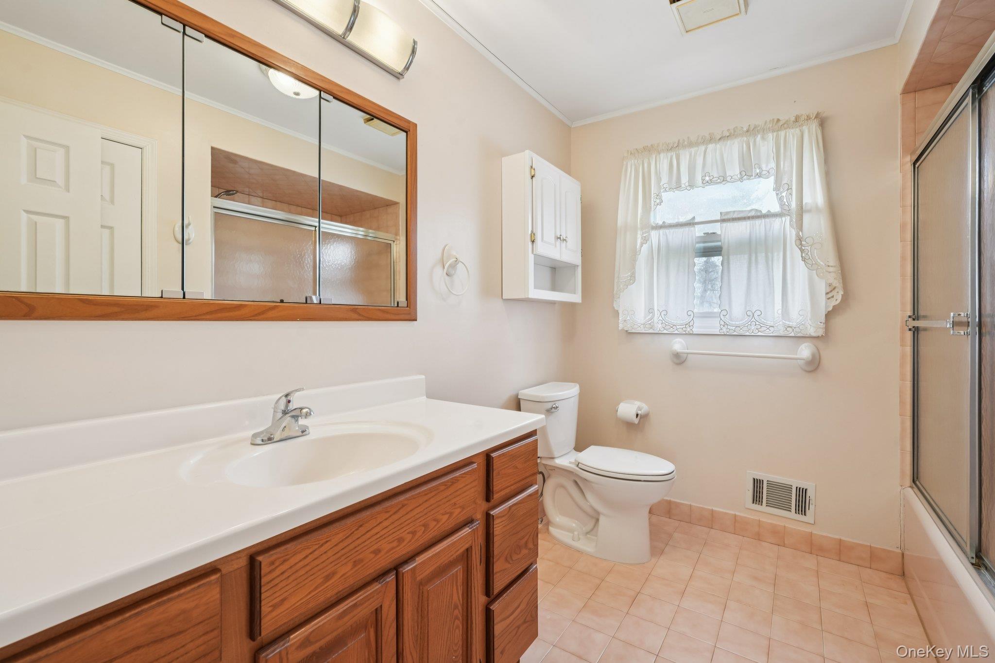 23 Oriole Road New City, NY 10956 - Photo 25 of 43 a bathroom with a sink a toilet and a mirror