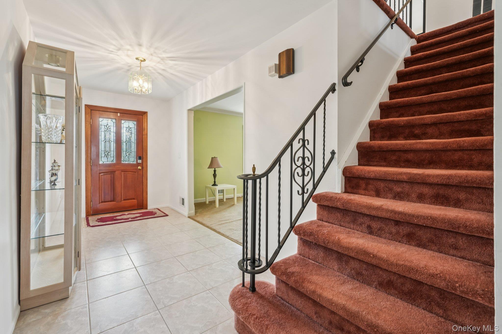 23 Oriole Road New City, NY 10956 - Photo 5 of 43 a view of an entryway with wooden floor and a chandelier