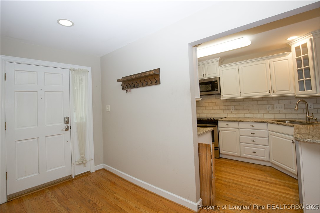 175 Knoll Road Southern Pines, NC 28387 - Photo 3 of 50 a kitchen with a sink cabinets and wooden floor