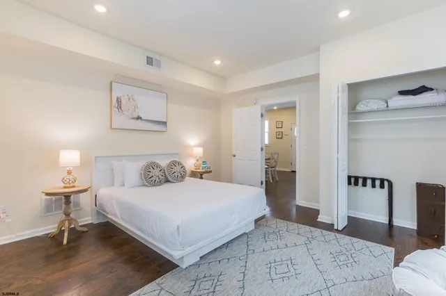 a bedroom with a large bed and a lamp