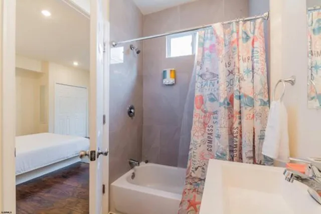 a bathroom with a bathtub and shower