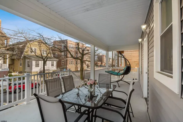 a view of a chairs and table in the balcony