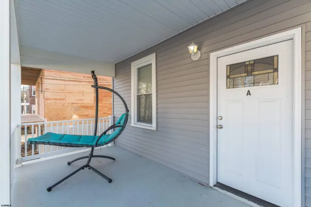 a view of staircase with a table and chairs