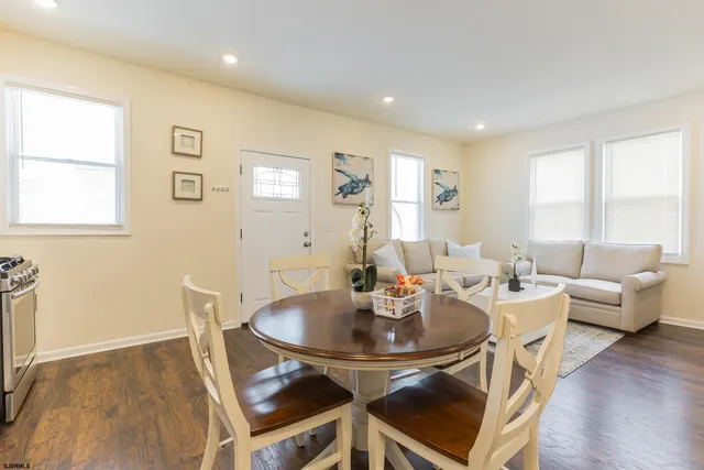 a dining room with furniture a window and wooden floor