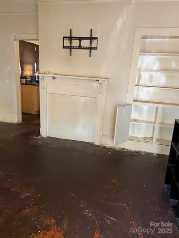 a view of a closet area with wooden floor