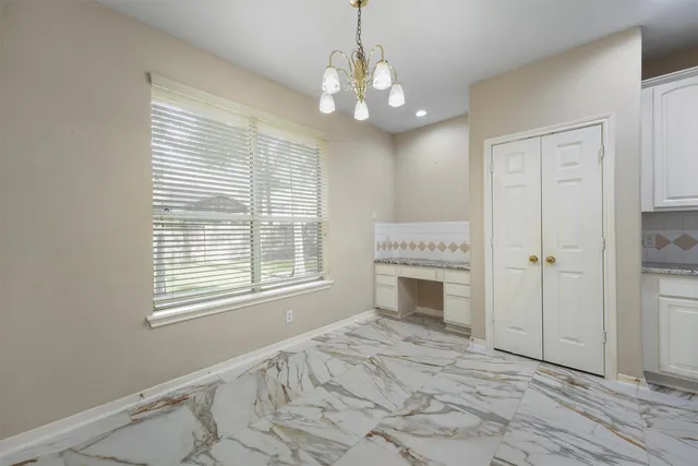 a view of an empty room with a fireplace and a window