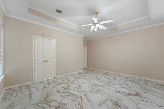 a view of a room with a ceiling fan