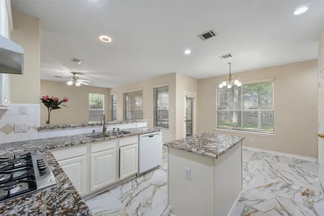 a large bathroom with a granite countertop sink a large mirror and a shower