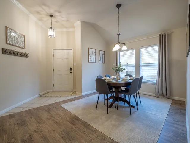 a bedroom with a bed and a lamp next to a window