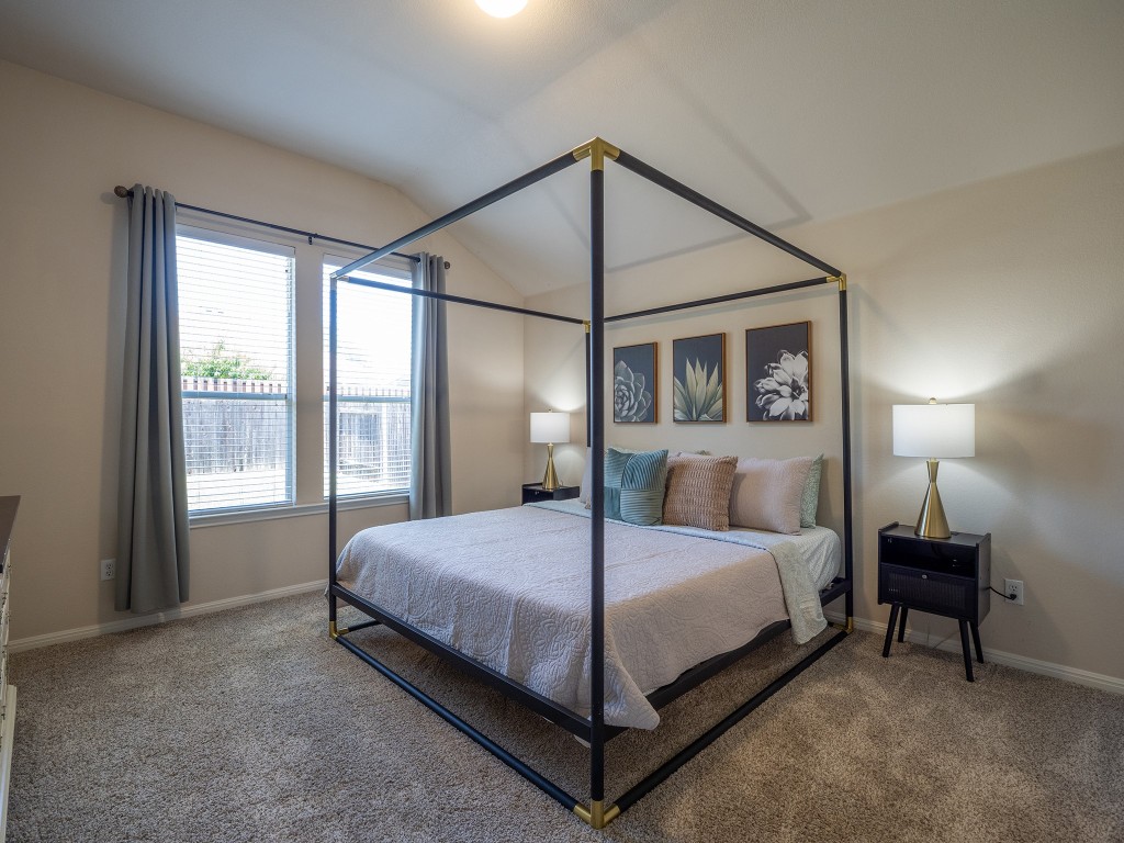 11620 Larch Valley Drive Austin, TX 78754 - Photo 14 of 24 a bedroom with a bed and a lamp next to a window