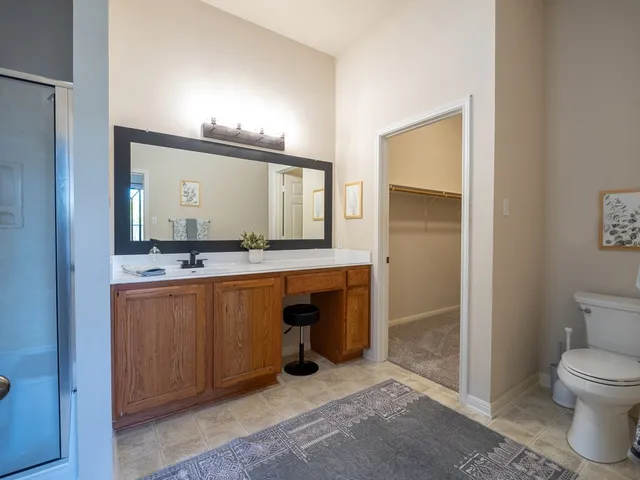 a bedroom with a bed a table and a chair