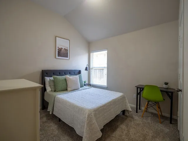 a bedroom with a bed and window