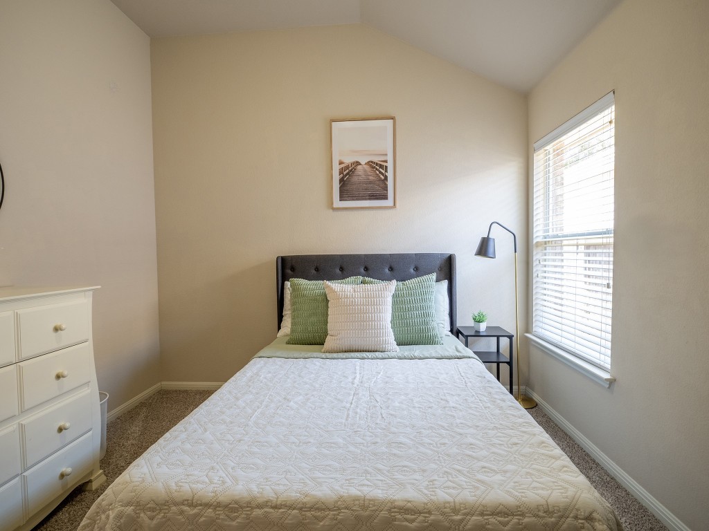 11620 Larch Valley Drive Austin, TX 78754 - Photo 20 of 24 a bed sitting in a bedroom next to a window