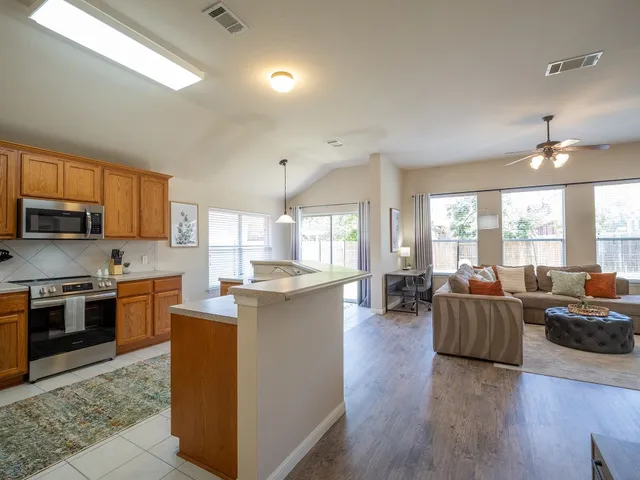 a kitchen with stainless steel appliances granite countertop a refrigerator sink and microwave