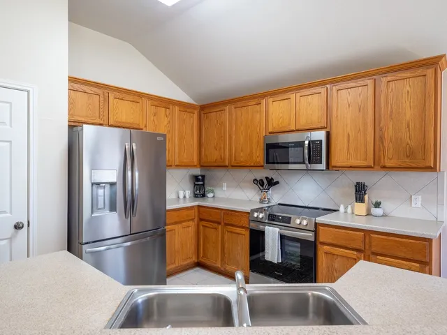 a kitchen with a stove a sink and a microwave