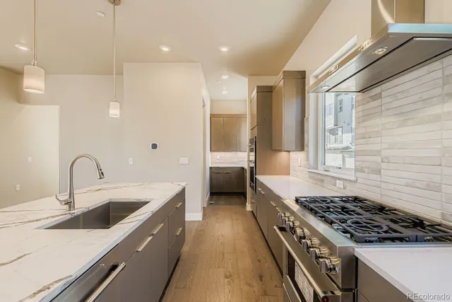 a kitchen with a sink stove top oven and cabinets
