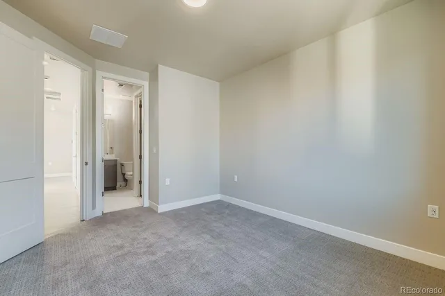 a bathroom with a bathtub shower sink vanity mirror and toilet