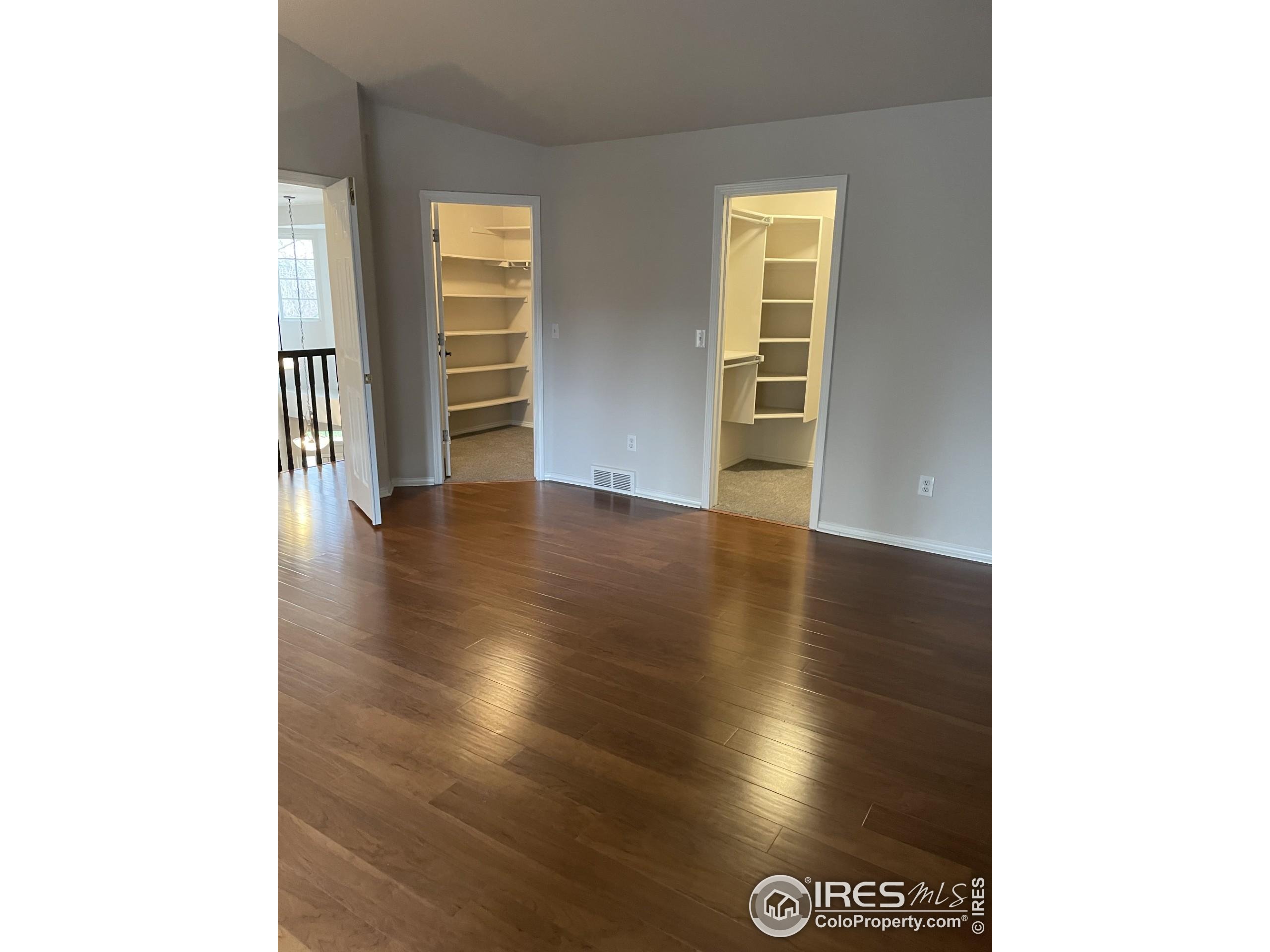 613 Rider Ridge Drive Longmont, CO 80504 - Photo 17 of 34 a view of an empty room with wooden floor and a window
