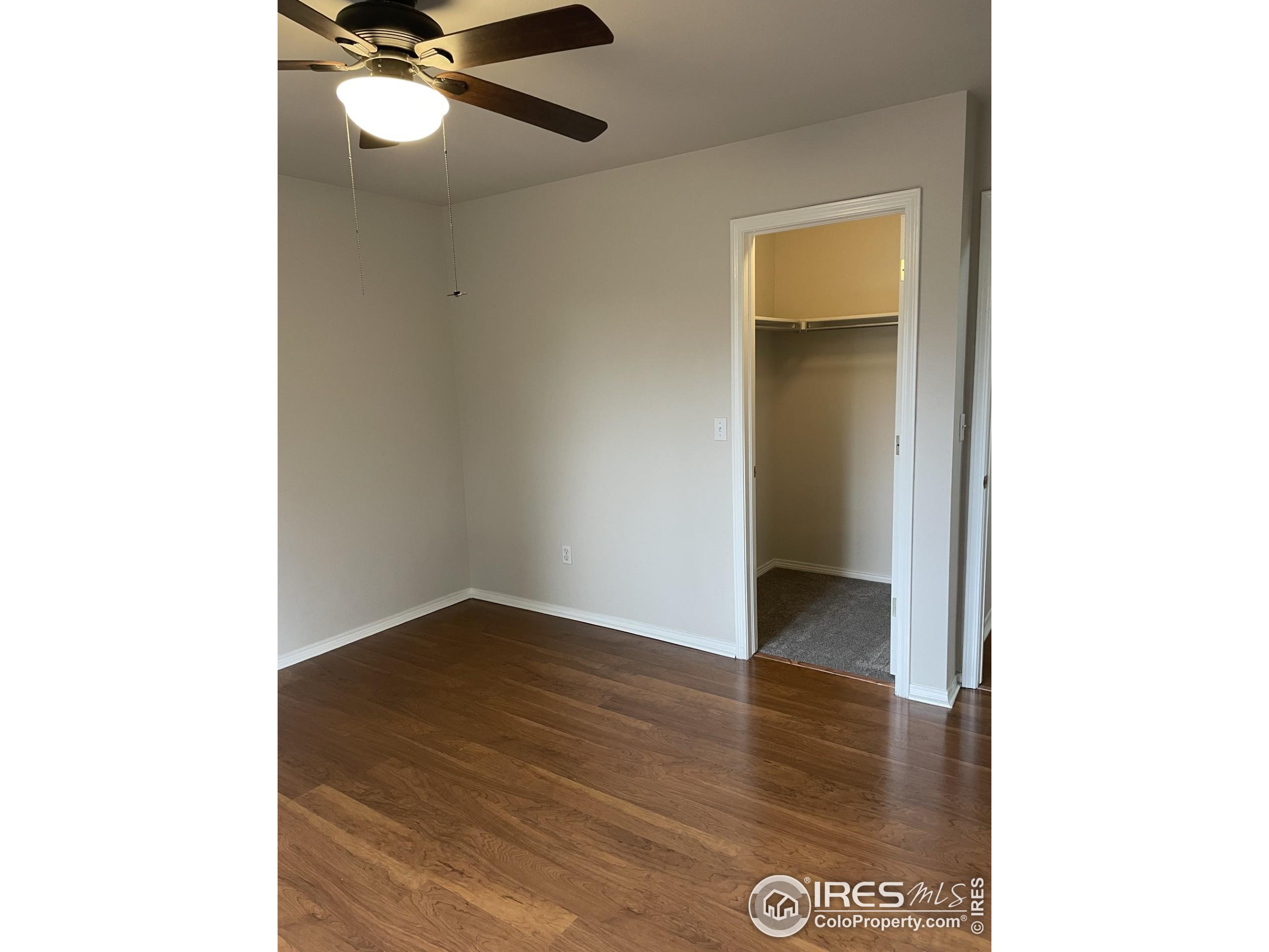 613 Rider Ridge Drive Longmont, CO 80504 - Photo 24 of 34 a view of an empty room with wooden floor