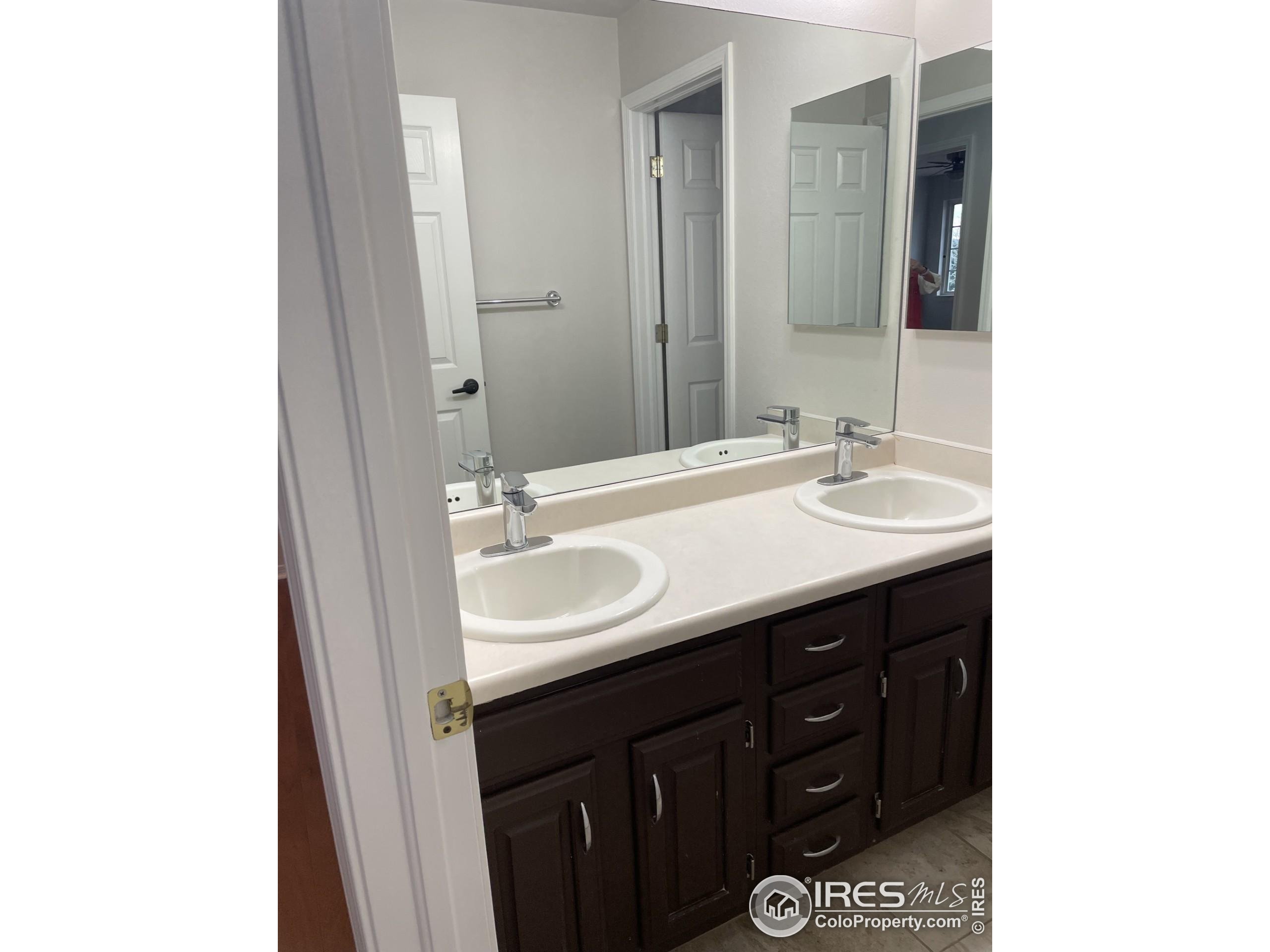 613 Rider Ridge Drive Longmont, CO 80504 - Photo 29 of 34 a bathroom with a sink and a mirror