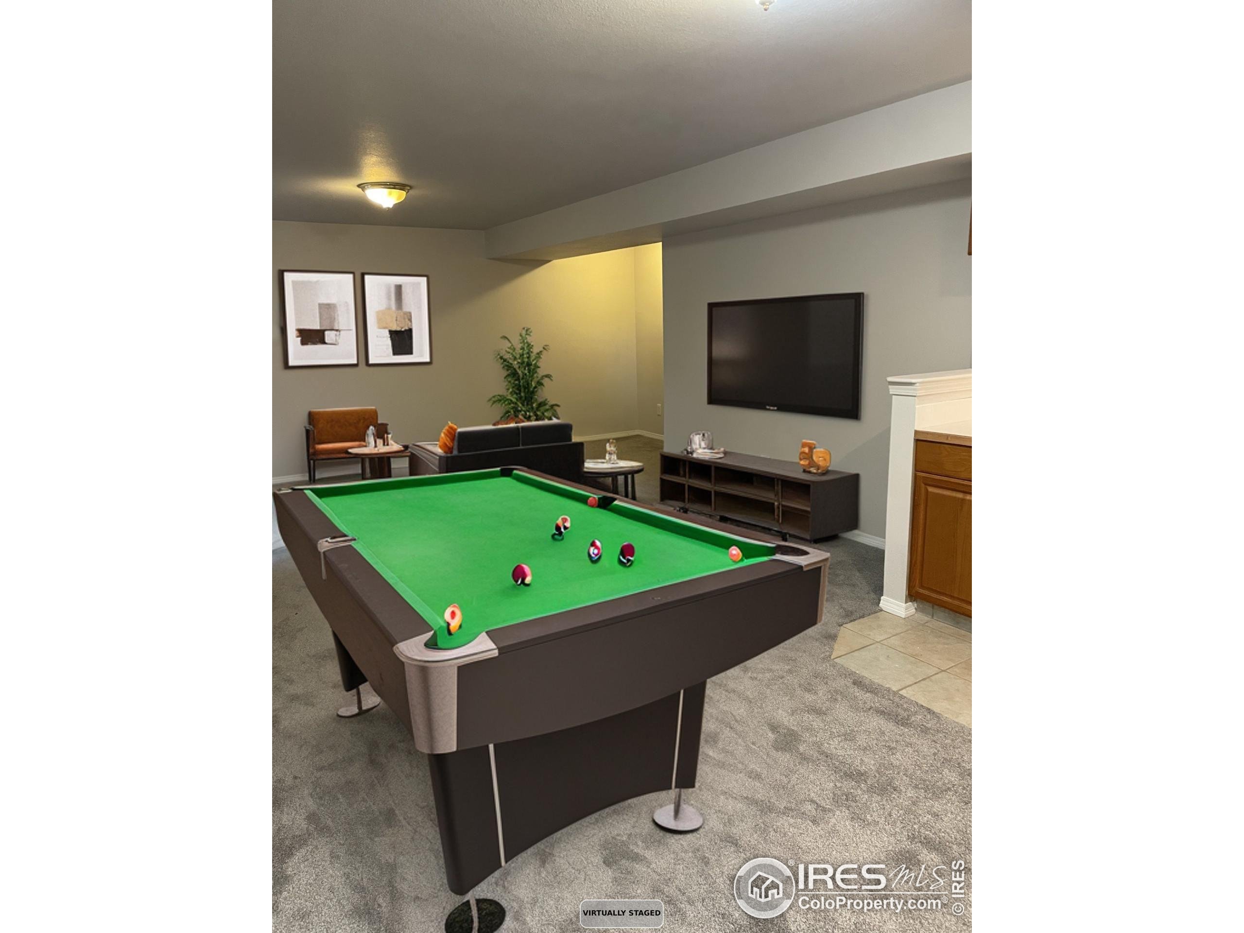 613 Rider Ridge Drive Longmont, CO 80504 - Photo 31 of 34 a room with pool table and a flat screen tv