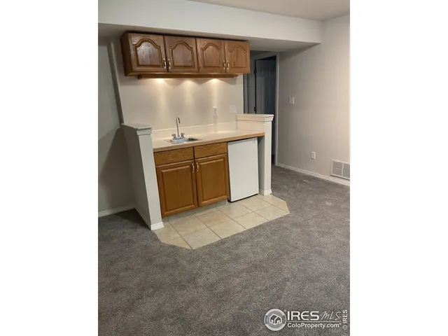 a living room with a bed furniture and a potted plant