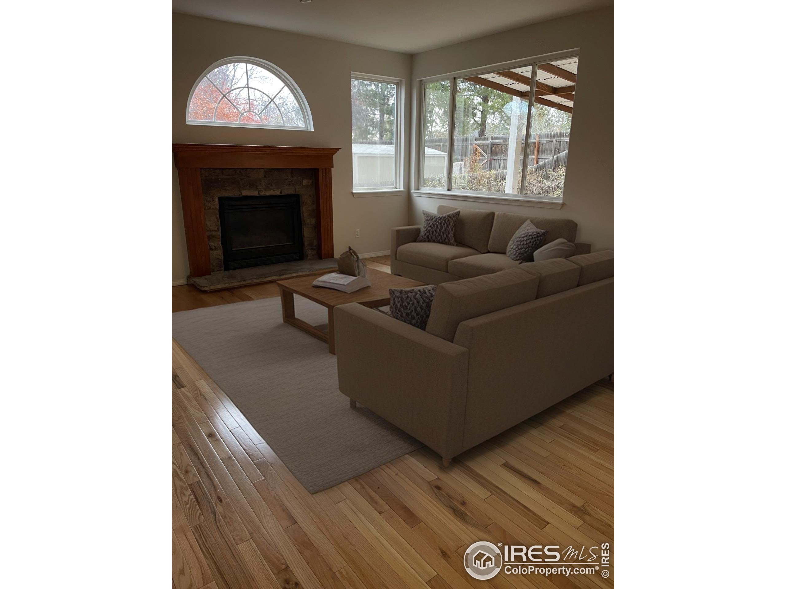 613 Rider Ridge Drive Longmont, CO 80504 - Photo 6 of 34 a living room with furniture and a fireplace