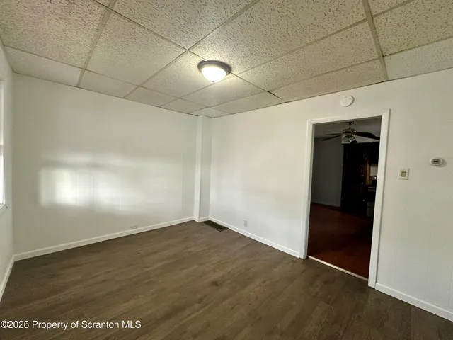 an empty room with wooden floor