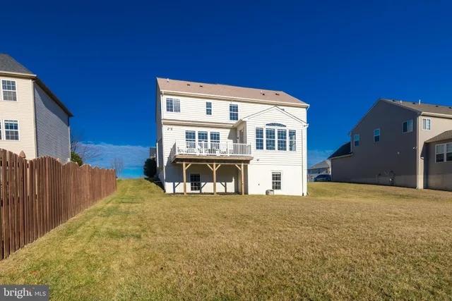 a view of a house with wooden fence