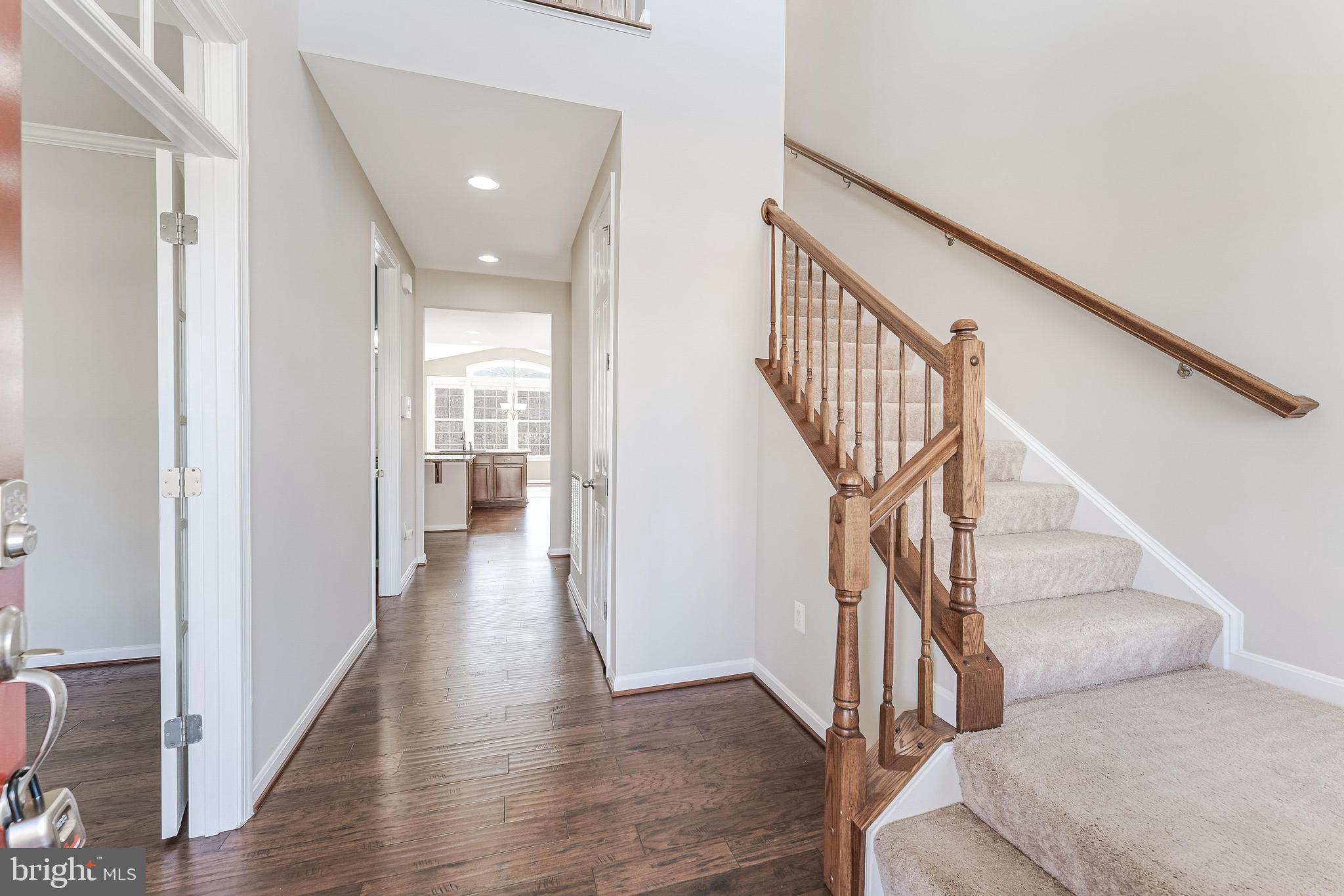 18747 Pier Trail Drive Triangle, VA 22172 - Photo 17 of 84 a view of a hallway with wooden floor and staircase