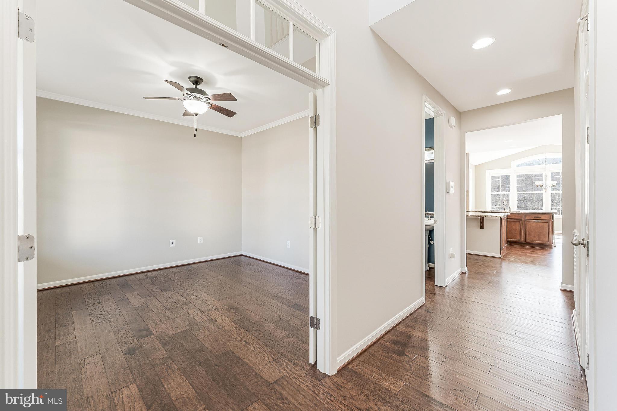 18747 Pier Trail Drive Triangle, VA 22172 - Photo 20 of 84 a view of a big room with wooden floor and a kitchen