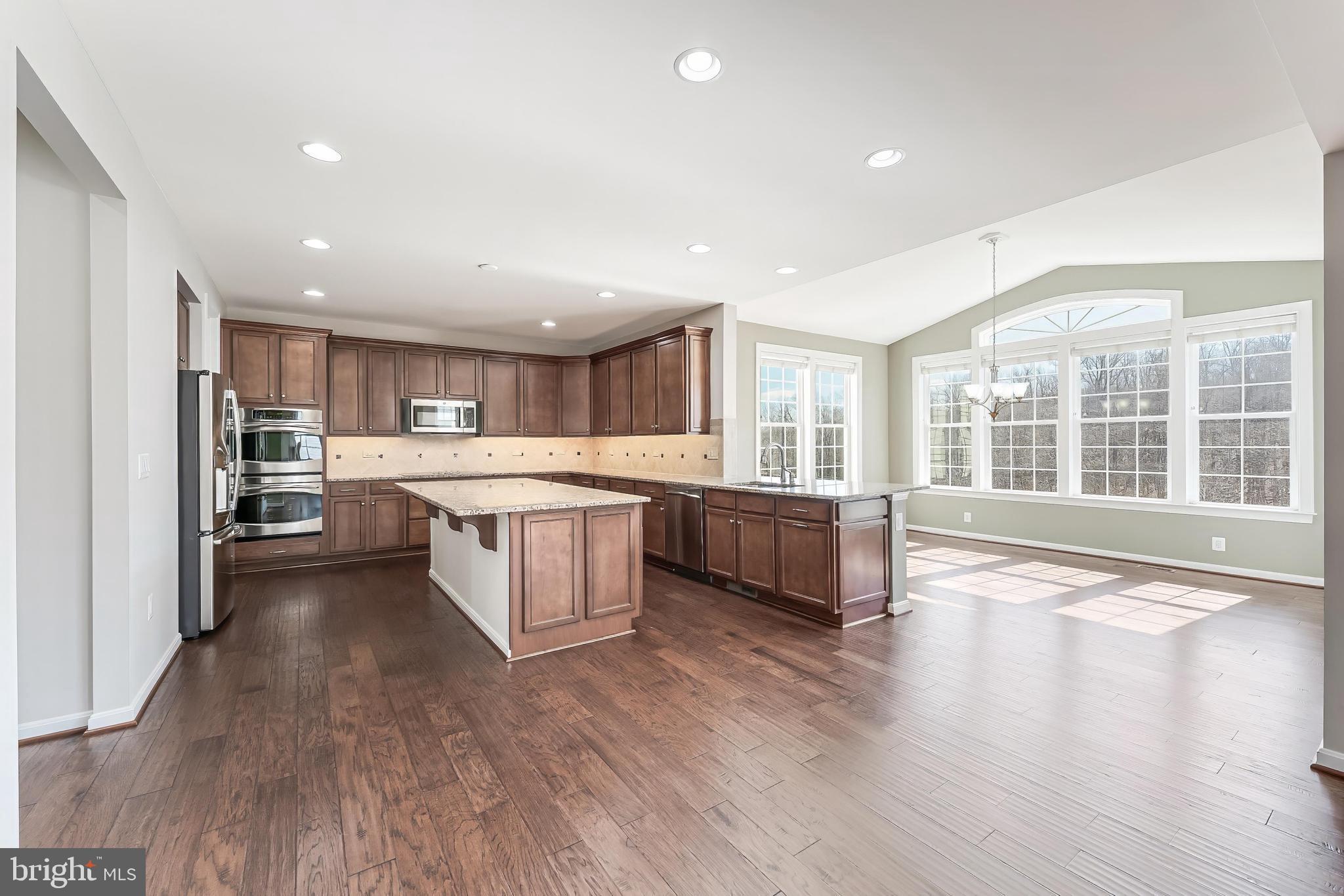 18747 Pier Trail Drive Triangle, VA 22172 - Photo 35 of 84 a large kitchen with stainless steel appliances granite countertop a large counter top a large window and a sink