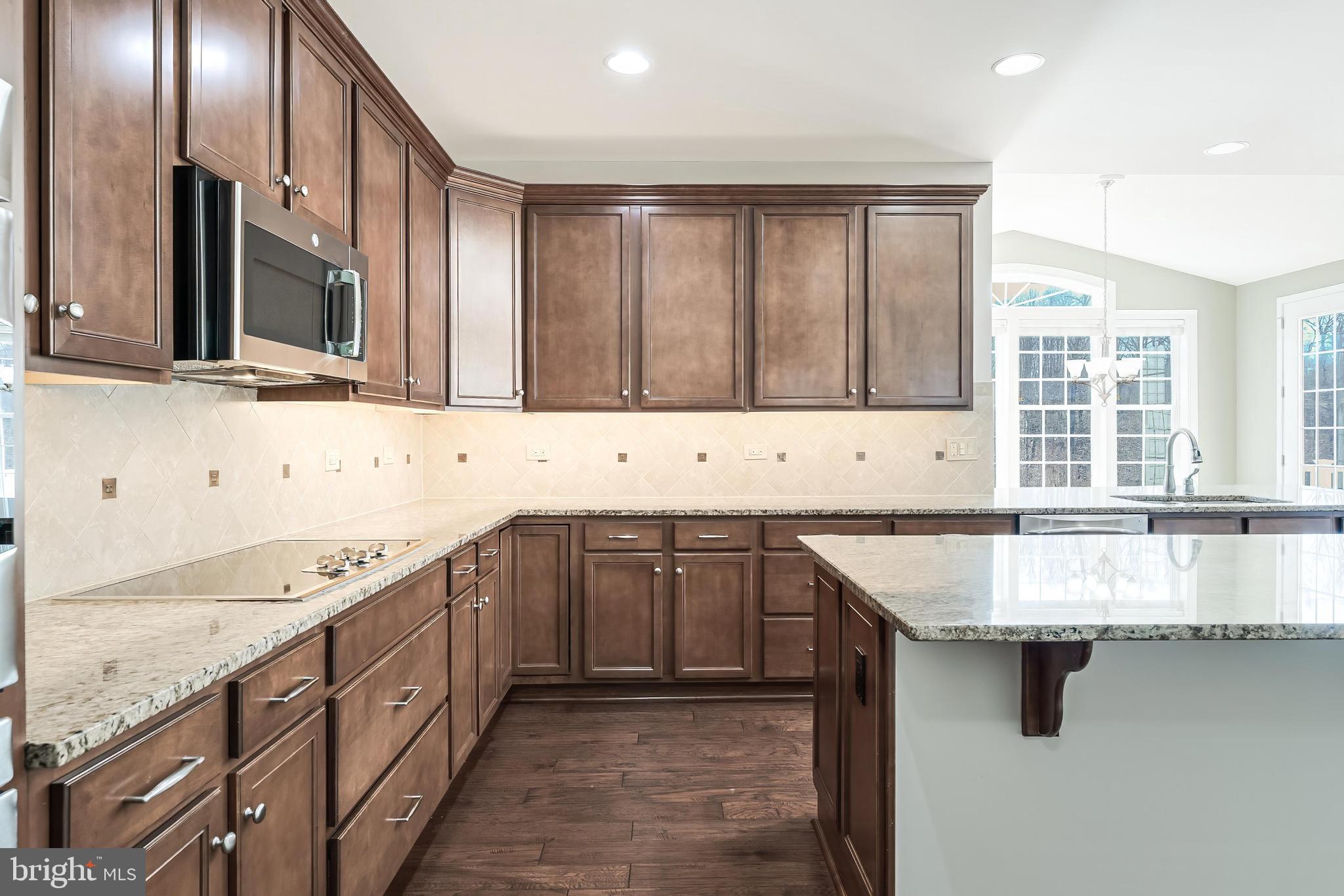 18747 Pier Trail Drive Triangle, VA 22172 - Photo 48 of 84 a kitchen with stainless steel appliances granite countertop a sink and a stove