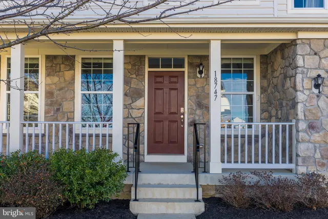 a view of a house with a small yard and wooden floor and fence
