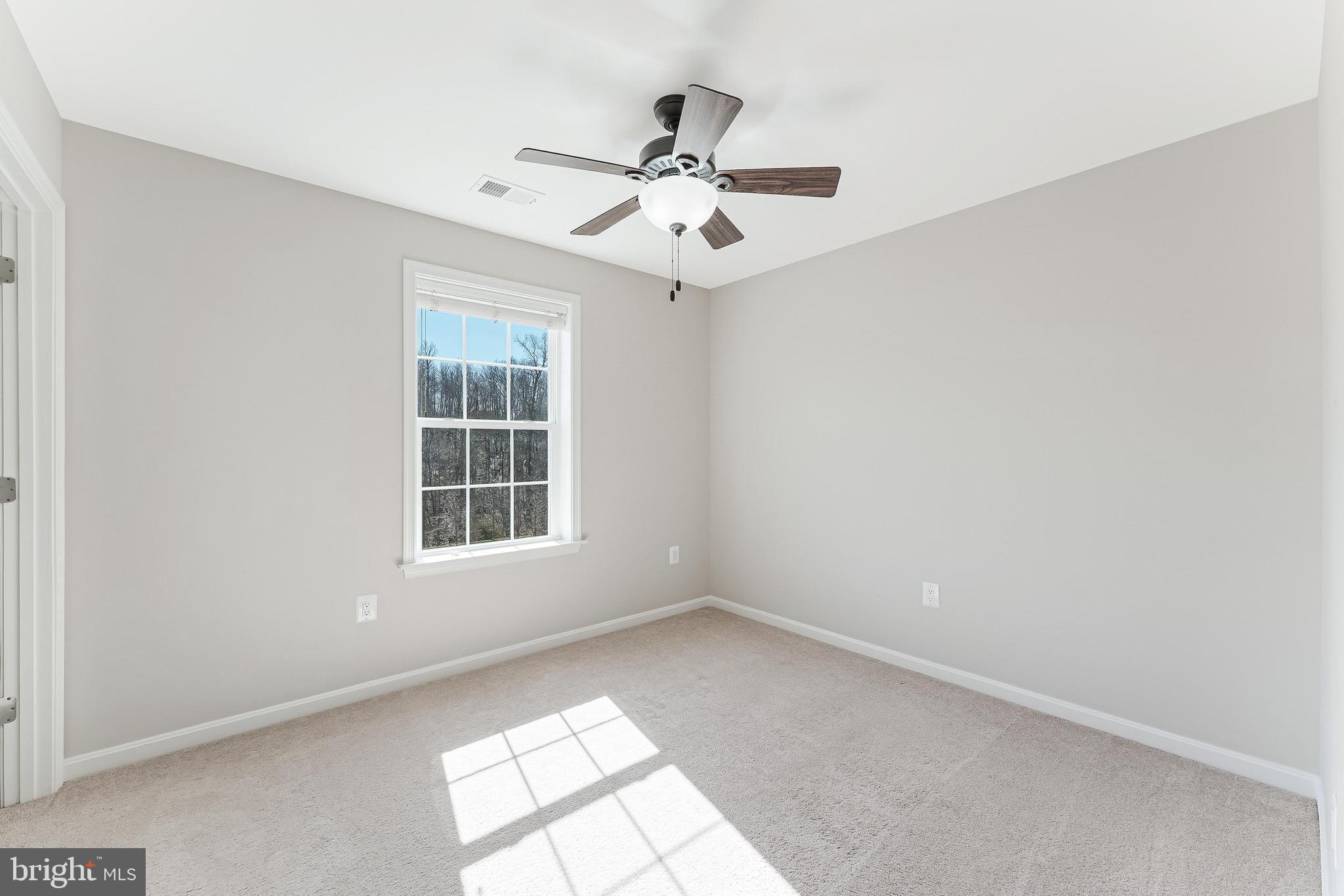 18747 Pier Trail Drive Triangle, VA 22172 - Photo 60 of 84 an empty room with windows and ceiling fan