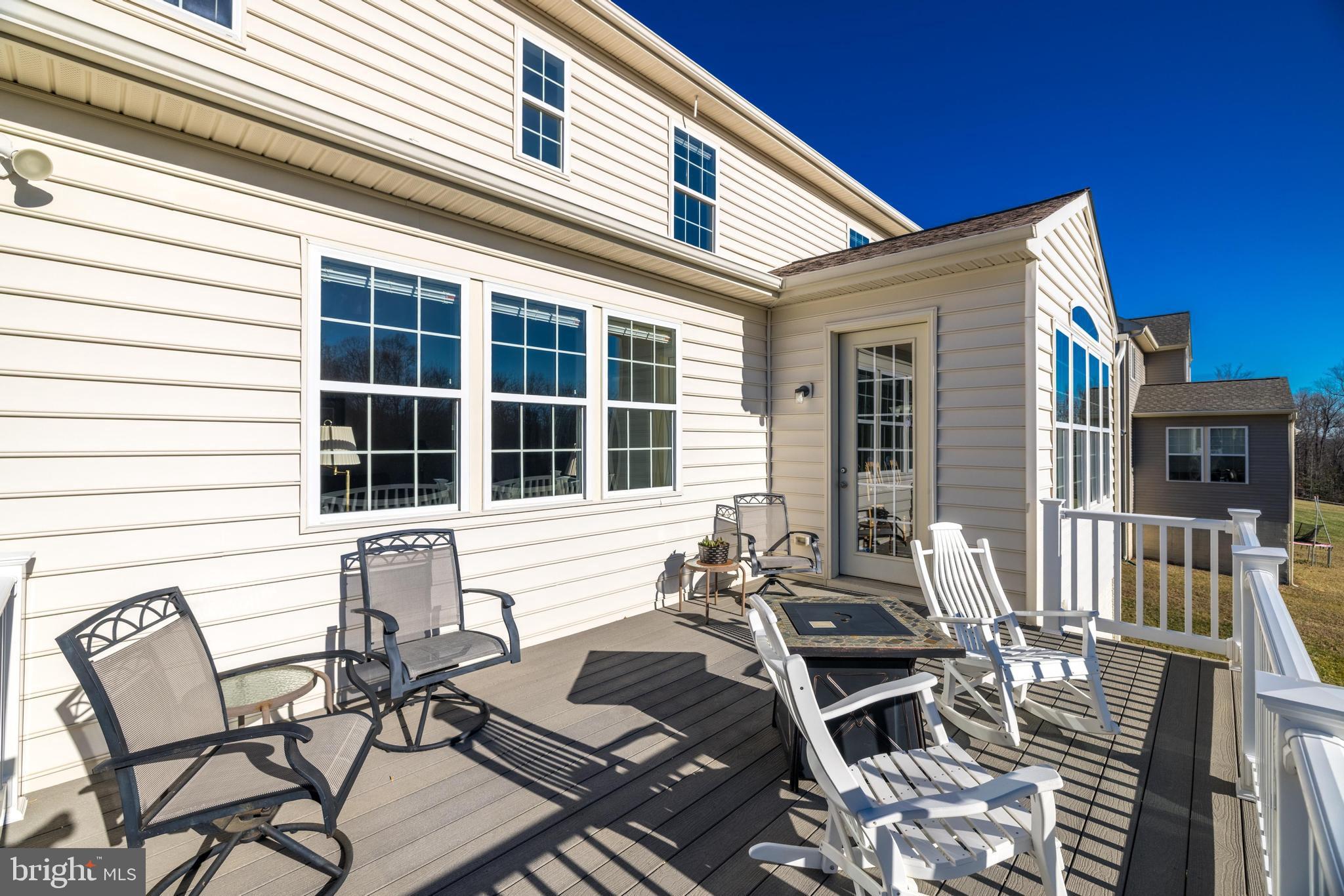 18747 Pier Trail Drive Triangle, VA 22172 - Photo 7 of 84 a view of a patio with table and chairs with wooden floor and fence