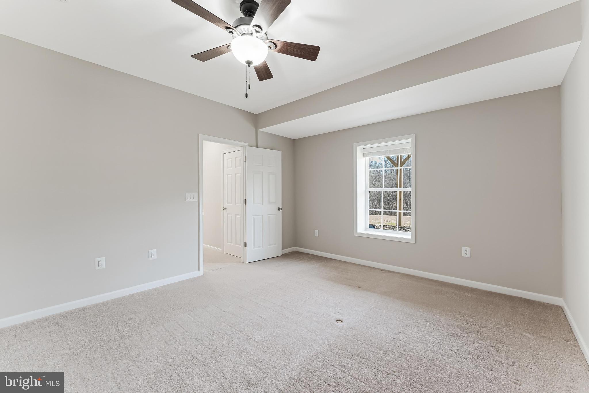 18747 Pier Trail Drive Triangle, VA 22172 - Photo 80 of 84 an empty room with chandelier fan and windows
