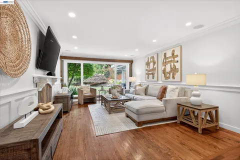 a living room with fireplace furniture and a flat screen tv
