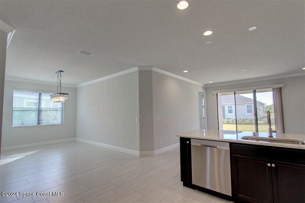 3267 Addison Drive Melbourne, FL 32940 - Photo 11 of 37 a kitchen with granite countertop a stove and a sink