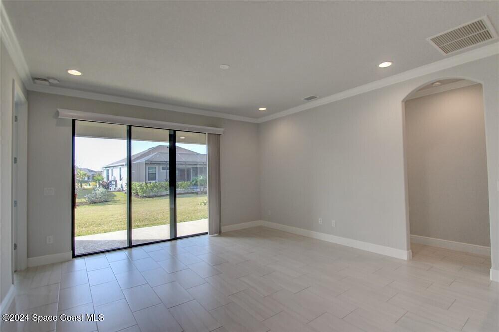 3267 Addison Drive Melbourne, FL 32940 - Photo 13 of 37 an empty room with wooden floor and windows
