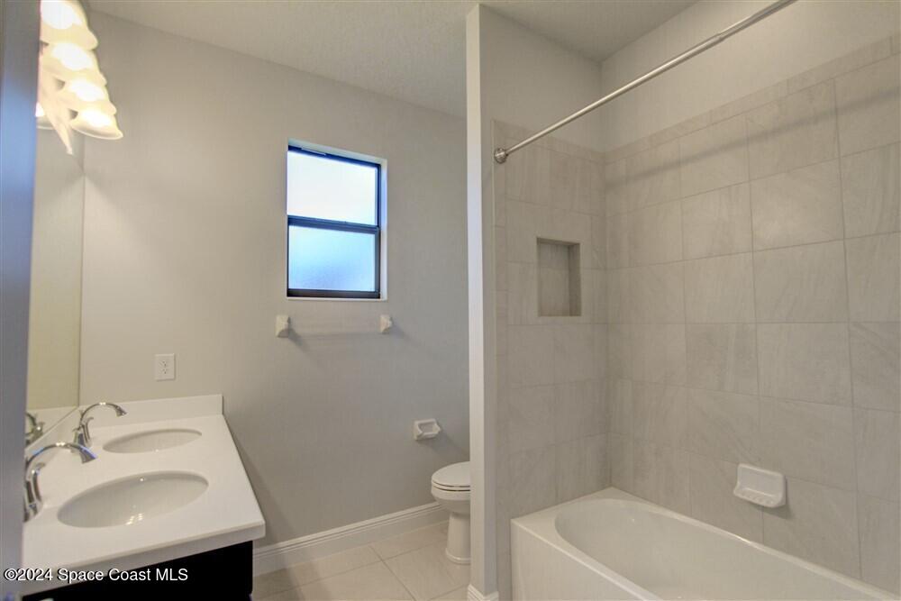 3267 Addison Drive Melbourne, FL 32940 - Photo 17 of 37 a bathroom with a sink toilet and shower